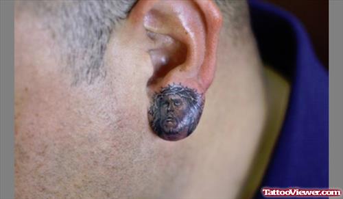 Grey Ink Jesus Head Ear Lobe Tattoo
