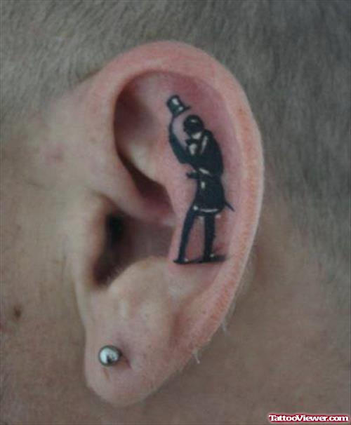 Black Ink Man With Hat Ear Tattoo