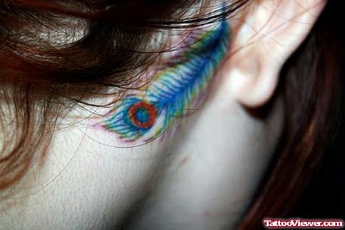 Awesome Colored Peacock Feather Ear Tattoo