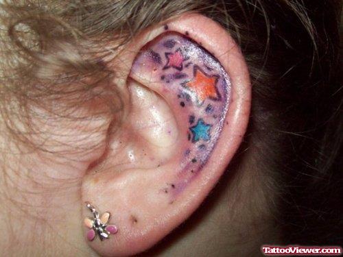 Amazing Colored Stars Left Ear Tattoo