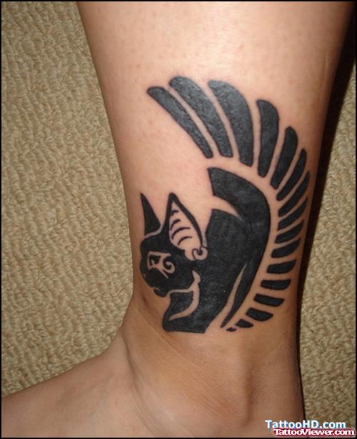 Black Ink Egyptian Winged Tattoo On Ankle