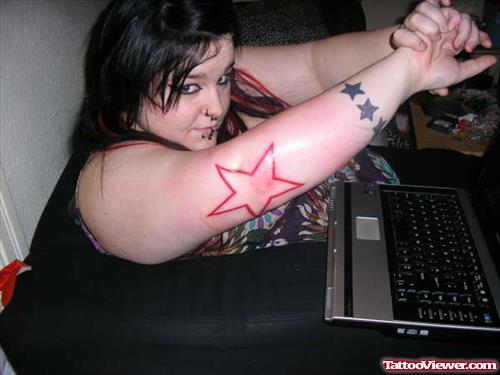 Girl With Red Star Tattoo On Elbow