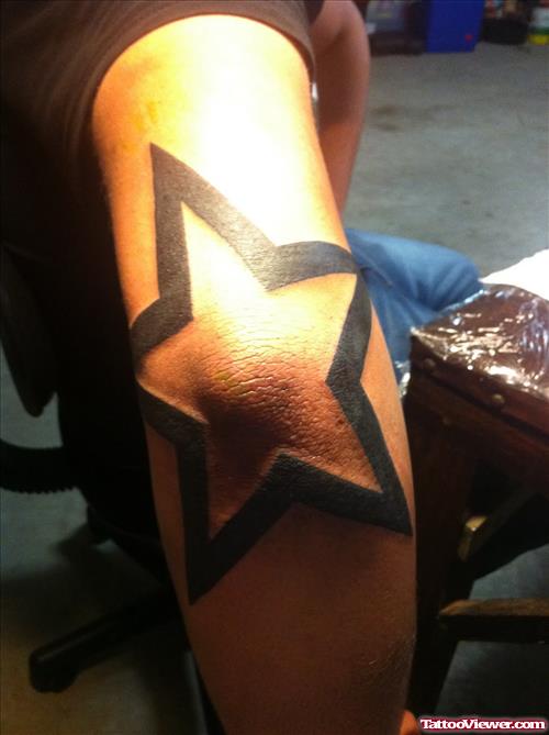 Black Star Tattoo On Right Elbow