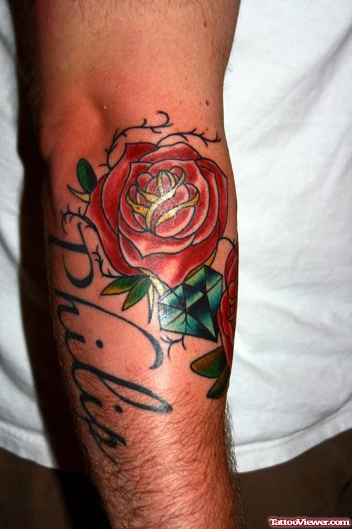 Blue Diamond And Red Rose Elbow Tattoo