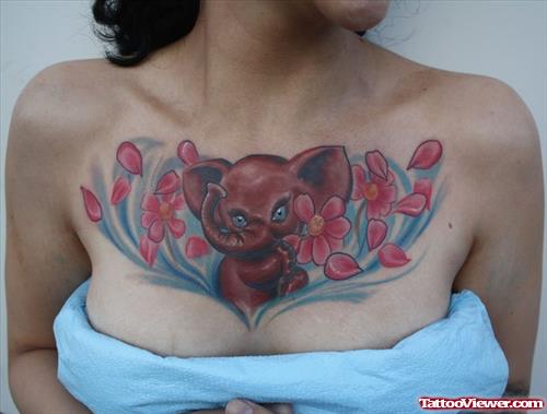 Pink Flowers And Elephant Tattoo On Girl Chest