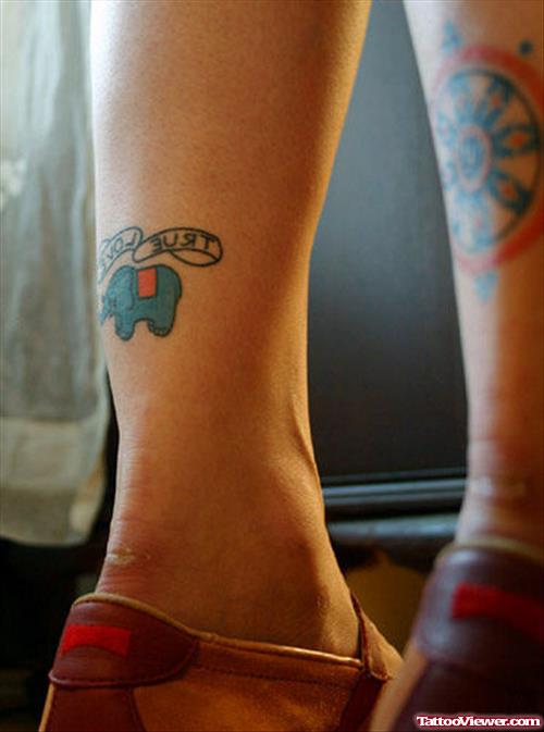 A Small Blue Elephant Tattoo With Trust Love Banner