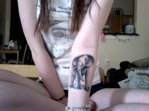 Girl Showing Her Elephant Tattoo On Left Forearm