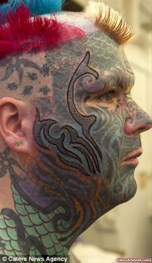 Colored Extreme Tribal Tattoo On Face