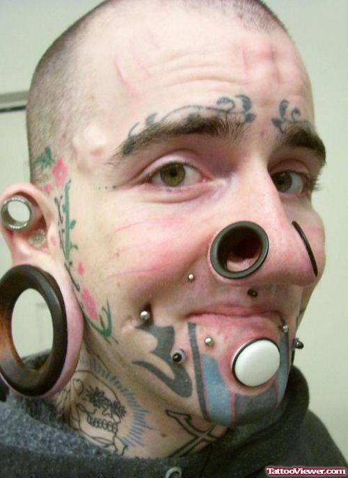 Extreme Piercings And Tattoos On Man Face