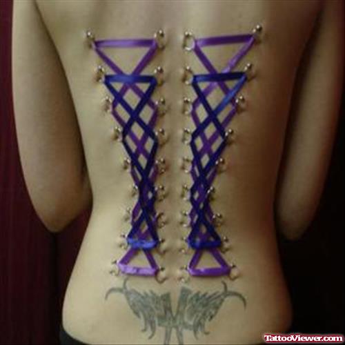 Corset And Tribal Extreme Tattoo On Lowerback