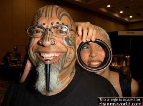 Awesome Black Extreme Tattoo On Firl Face