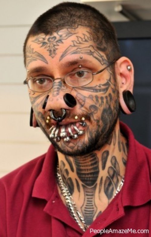 Extreme Black Ink Face And Throat Tattoo