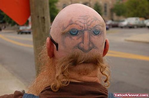 Man With Face and Eyes Tattoos On Back Head