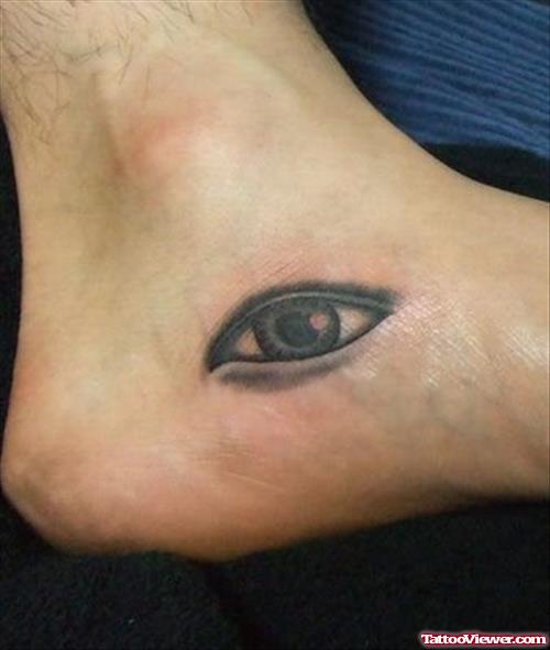 Grey Ink Eye Tattoo On Left Foot