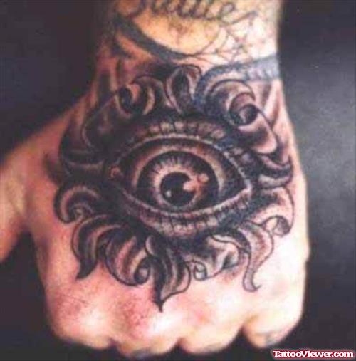 Grey Ink Flower Eye Tattoo On Left Hand