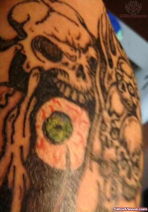 Grey Ink Skull And Green Eye Arm Tattoo