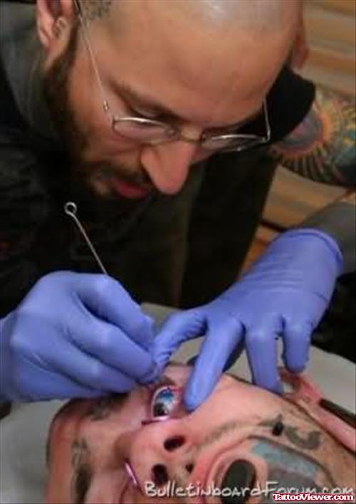 Guy Getting Eye Tattoo