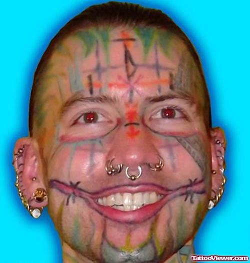 Awesome Colored Tribal Face Tattoo