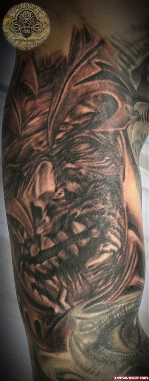 Grey Ink Tribal and Zombie Face Tattoo