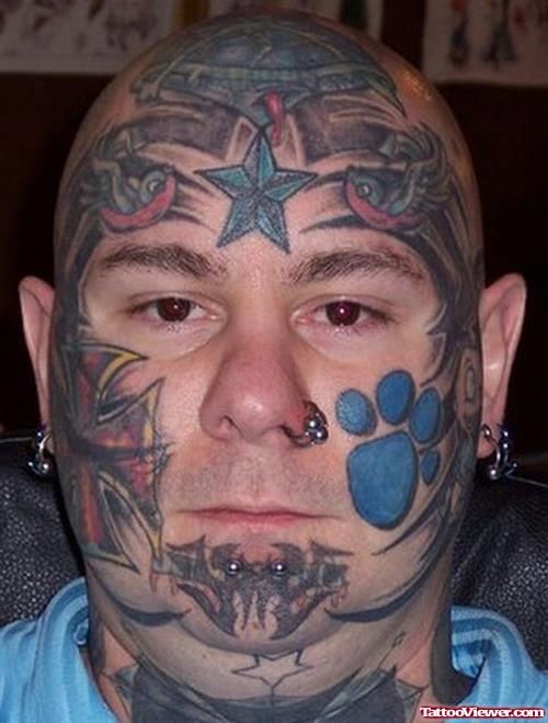 Tribal And Nautical Star And Paw Print Face Tattoo