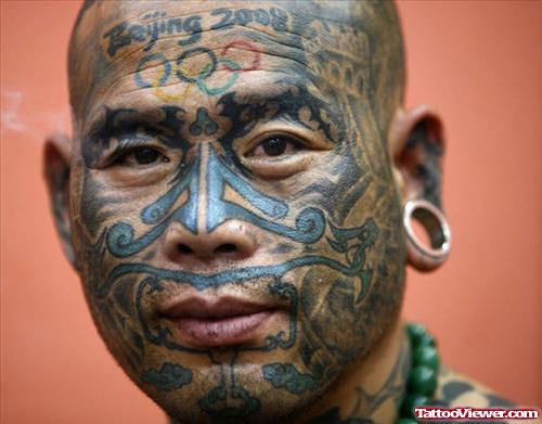Olympic Logo And Tribal Face Tattoo