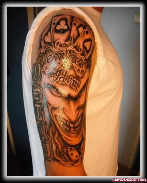 Grey Ink Poker Cards And Face Tattoo On Half Sleeve