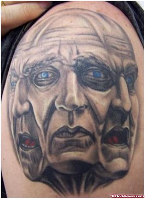Grey Ink Three Face Tattoos On Shoulder