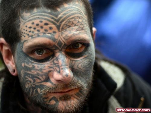 Amazing Black Ink Tribal Face Tattoo
