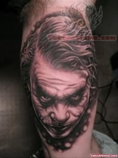 Grey Ink Joker Face Tattoo