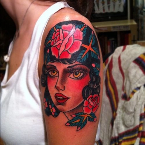 Flowers And Girl Face Tattoo On Left Shoulder