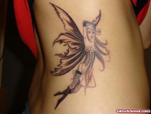 Grey Ink Flying Fairy Side Rib Tattoo
