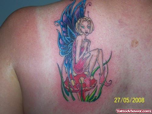 Colored Ink Fairy Sitting On Mushroom Tattoo