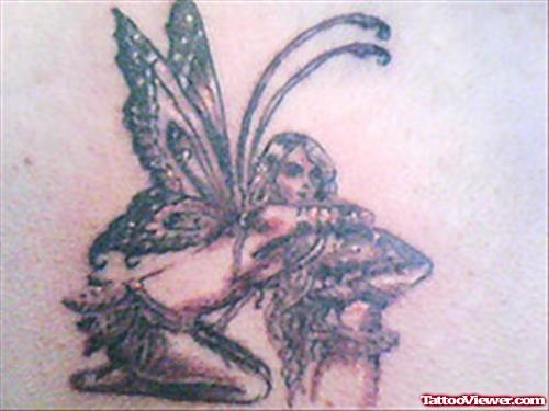 Grey Ink Mushroom And Fairy Tattoo