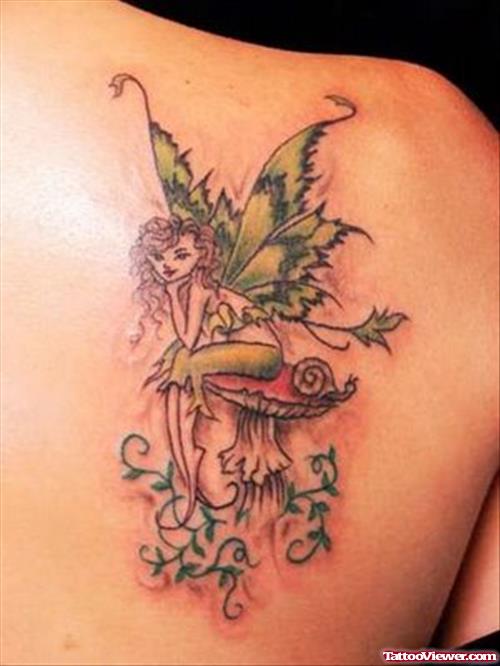 Fairy Sitting On Mushroom Tattoo On Back Shoulder