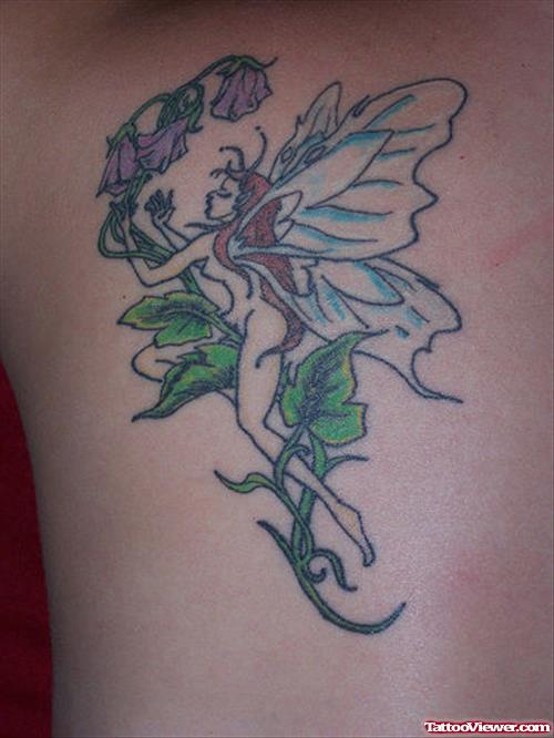 Attractive Colored Flowers And Fairy Tattoo