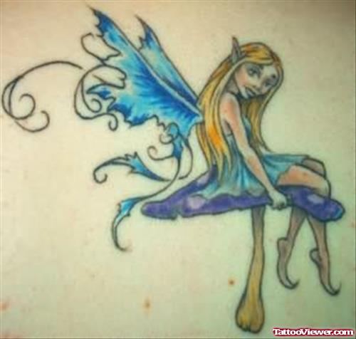 Beautiful Fairy Tattoo Sitting On Mushroom