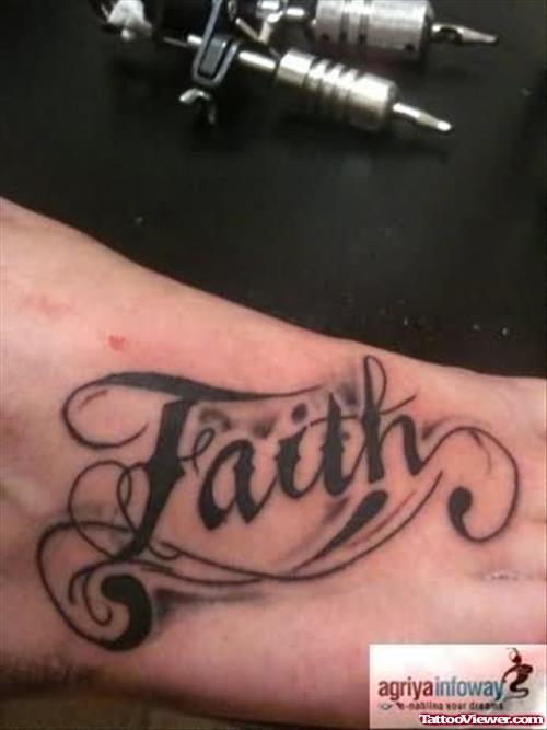 Black Ink Faith Tattoo On Right Foot