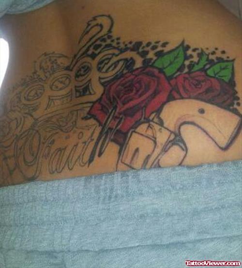 Rose Flower Gun And Faith Tattoo On Lowerback