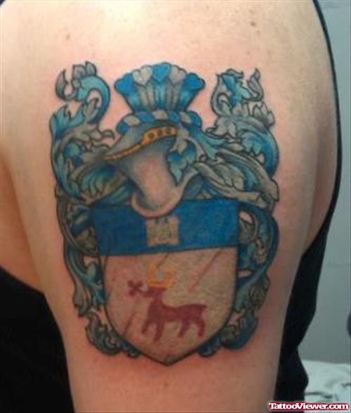Blue Ink Family Crest Tattoo On Left Shoulder