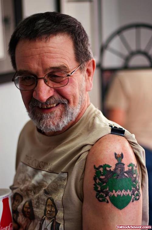 Green Ink Family Crest Tattoo On Left Shoulder