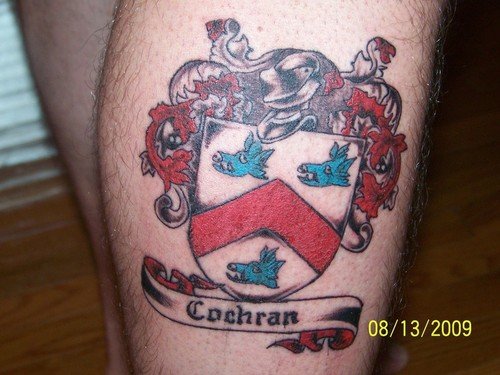 Colored Family Crest Tattoo On Right Leg