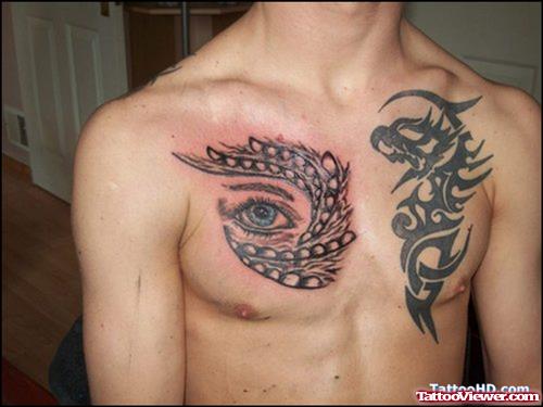 Tribal And Eye Fantasy Tattoos On Man Chest