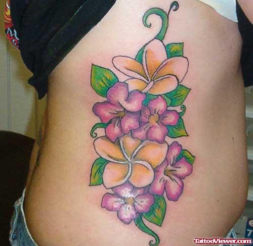 Colored Flowers Fantasy Tattoo On Rib Side