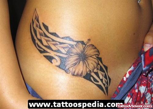 Grey Ink Flower And Hawaiian Fantasy Tattoo On Hip