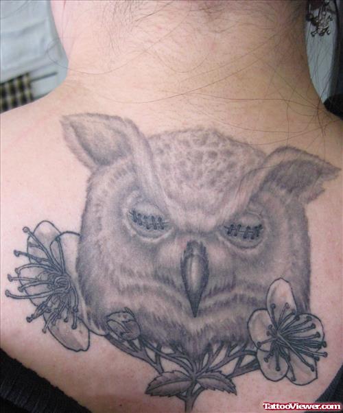 Grey Flowers And Owl Head Fantasy Tattoo On Upperback