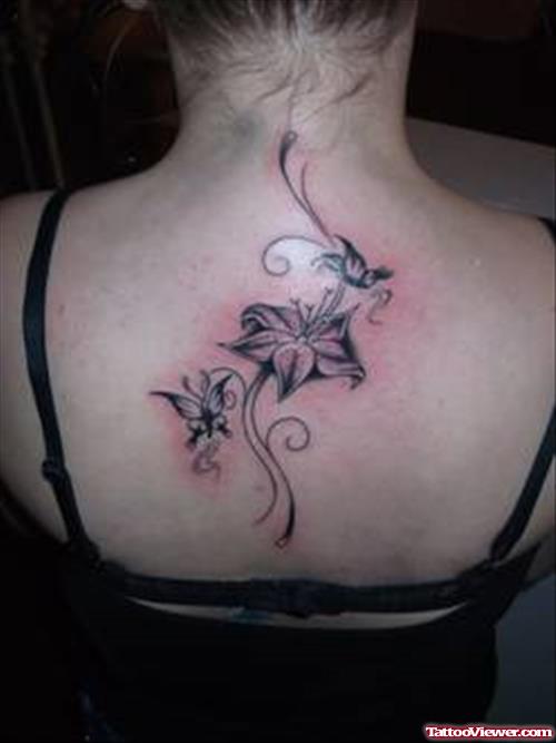 Grey Ink Flowers Fantasy Tattoo On Girl Upperback