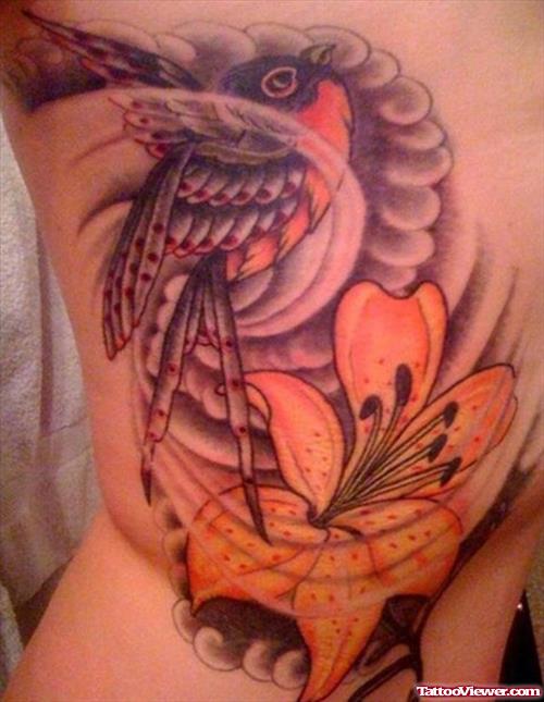 Color Flowers And Bird Fantasy Tattoo On Side Rib