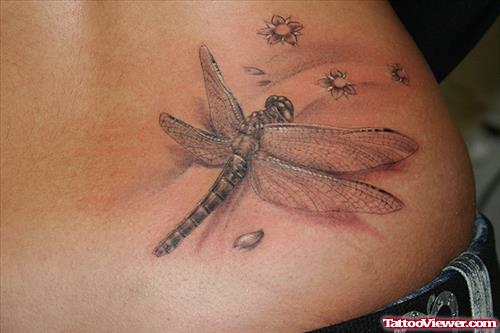 Grey Flowers And Dragonfly Fantasy Tattoo On Lowerback