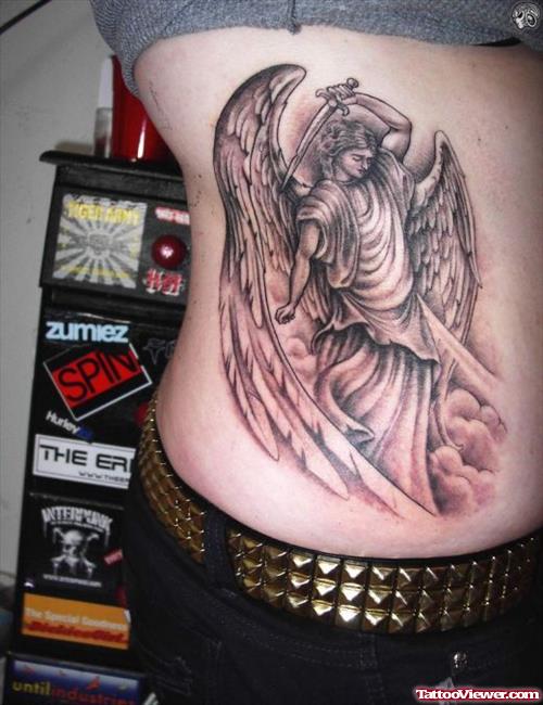 Grey Ink Angel And Dagger Fantasy Tattoo On Side Rib