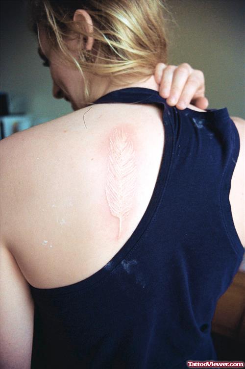 White Ink Feather Tattoo On Back